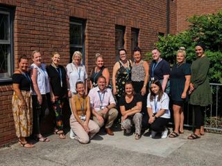 Photo of seated woman holding man’s hand