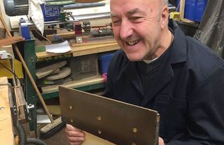 Member of Second Chance in woodworking room.